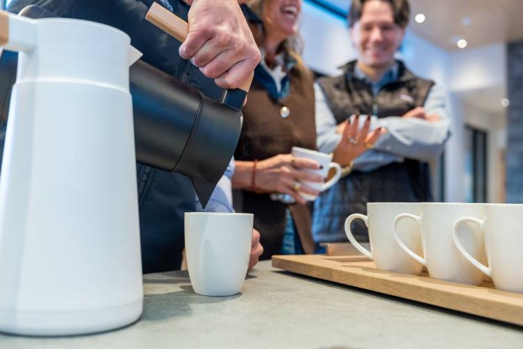 A guest pouring coffee