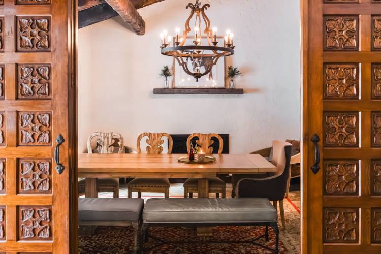 Wood doors that lead to a dining room