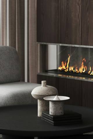 A sitting space with a fireplace and a table and chair
